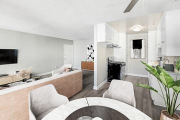 North Hills apartment for rent - A living room with a grey couch and a white chair.