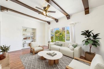 Los Angeles apartment for rent - A living room with a white couch, a coffee table, and a ceiling fan.
