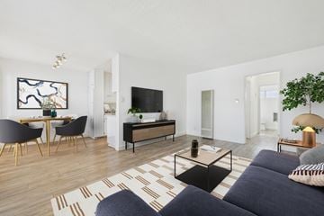 Los Angeles apartment for rent - A living room with a black sofa and a wooden floor.