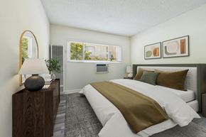 Los Angeles apartment for rent - A bedroom with a large bed and a lamp on a wooden stand.