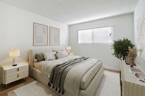 Los Angeles apartment for rent - A bedroom with a large bed and a nightstand with a lamp.