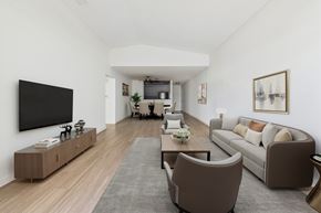 Northridge apartment for rent - A living room with a grey rug and brown chairs.