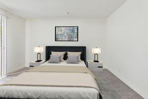 Northridge apartment for rent - A bedroom with a large bed and two lamps.
