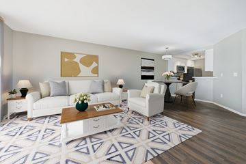 Los Angeles apartment for rent - A living room with a white couch, a coffee table, and a painting on the wall.