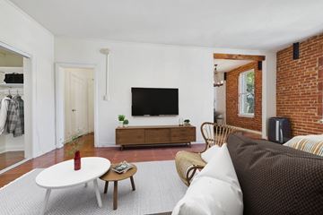 Los Angeles apartment for rent - A living room with a white couch and a wooden coffee table.