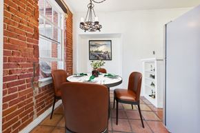 Los Angeles apartment for rent - A dining room with a table set for two and a chandelier hanging from the ceiling.