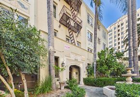 Los Angeles apartment for rent - A building with a balcony and a fountain in front of it.