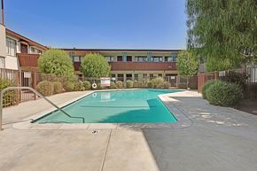 Sherman Oaks apartment for rent - A swimming pool in front of a building.