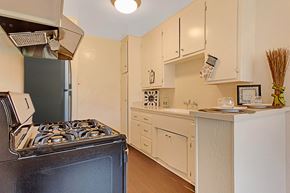 Sherman Oaks apartment for rent - A black stove sits in a kitchen with white cabinets.