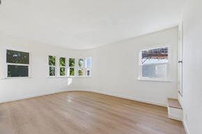 Los Angeles apartment for rent - A room with a white wall and a window with a view of a snowy landscape.