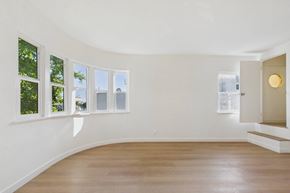 Los Angeles apartment for rent - A room with a wooden floor and white walls.