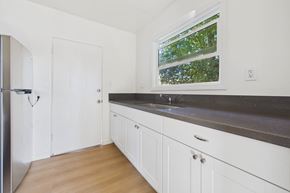 Los Angeles apartment for rent - A kitchen with white cabinets and a window.
