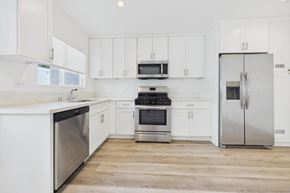 Los Angeles apartment for rent - A kitchen with white cabinets and stainless steel appliances.