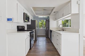 Los Angeles apartment for rent - A modern kitchen with white cabinets and appliances.