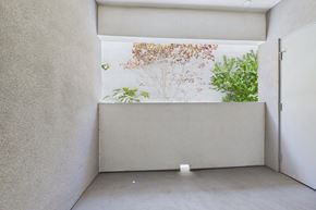 Winnetka apartment for rent - A room with a white wall and a window with a view of trees.