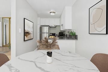 Torrance apartment for rent - A modern kitchen with a marble table and a framed picture on the wall.