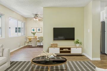 Torrance apartment for rent - A living room with a black coffee table and a flat screen TV mounted on the wall.