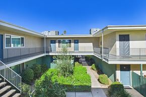 Canoga Park apartment for rent - A sunny day at a residential complex with a clear blue sky.