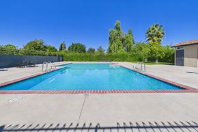 Canoga Park apartment for rent - A large outdoor swimming pool with a red and white border.