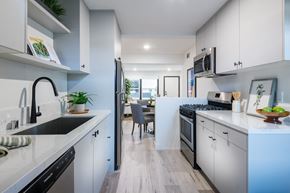 Pasadena apartment for rent - A modern kitchen with white cabinets and a wooden floor.