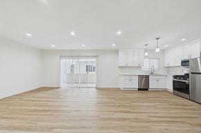 Burbank apartment for rent - A kitchen with white cabinets and a wooden floor.