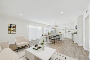 Burbank apartment for rent - A modern kitchen and living room with a dining table and chairs.