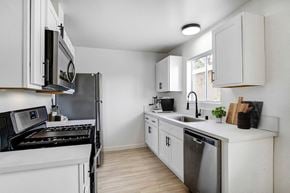 Ventura apartment for rent - a kitchen with white cabinets and stainless steel appliances