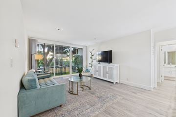 Santa Monica apartment for rent - A living room with a green couch and a television.