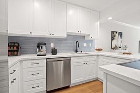 Santa Monica apartment for rent - a white kitchen with stainless steel appliances and white cabinets