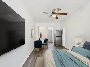 Los Angeles apartment for rent - A bedroom with a bed, chair, and a ceiling fan.