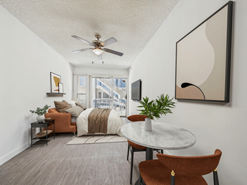 Los Angeles apartment for rent - A living room with a brown chair and a white table.