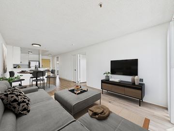 Los Angeles apartment for rent - A living room with a grey couch and a wooden cabinet.