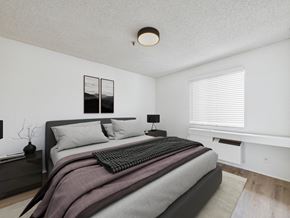 Los Angeles apartment for rent - A bedroom with a large bed and a window with blinds.