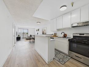 Los Angeles apartment for rent - A kitchen with a white counter and a black stove.