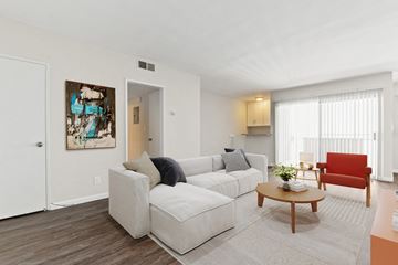 Los Angeles apartment for rent - A living room with a white couch and a red chair.
