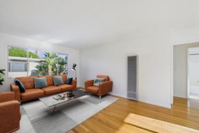 Santa Monica apartment for rent - A living room with a brown couch, a grey coffee table, and a grey rug.