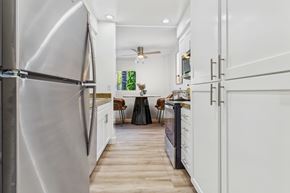 Sherman Oaks apartment for rent - A modern kitchen with a stainless steel refrigerator and white cabinets.