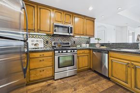 Sherman Oaks apartment for rent - A kitchen with wooden cabinets and stainless steel appliances.