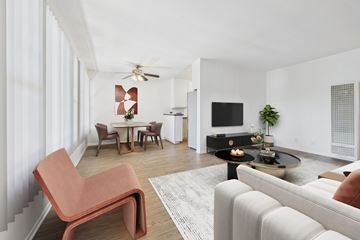 Sherman Oaks apartment for rent - A living room with a white couch and a red chair.
