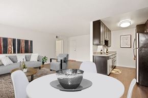 Sherman Oaks apartment for rent - a living room and dining room with a white table and chairs