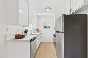 Sherman Oaks apartment for rent - A kitchen with white cabinets and a black refrigerator.
