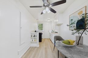 Long Beach apartment for rent - A modern kitchen with a dining table and a ceiling fan.