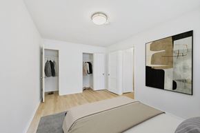 Long Beach apartment for rent - A room with a bed, a wardrobe and a painting on the wall.