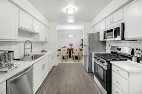 Sherman Oaks apartment for rent - a kitchen with stainless steel appliances and white cabinets