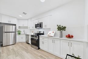 Sherman Oaks apartment for rent - A kitchen with white cabinets and a wooden floor.