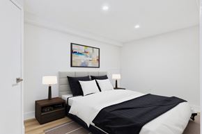 Sherman Oaks apartment for rent - A bedroom with a large bed and a painting on the wall.