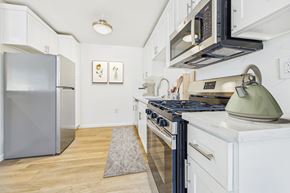 Sherman Oaks apartment for rent - A kitchen with a stove, refrigerator, and microwave.