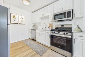 Sherman Oaks apartment for rent - A kitchen with white cabinets and a stainless steel oven.