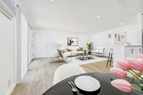 Sherman Oaks apartment for rent - A modern living room with a dining table set for two.