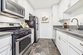 Sherman Oaks apartment for rent - A modern kitchen with a stove top oven and a refrigerator.